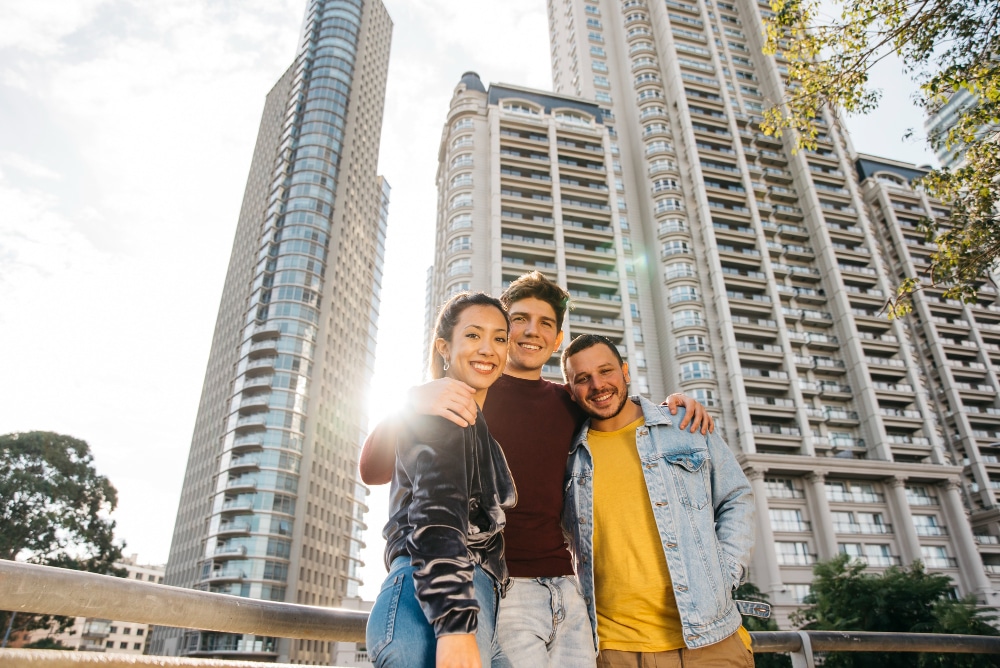 Group of friends in front of high-rise apartments